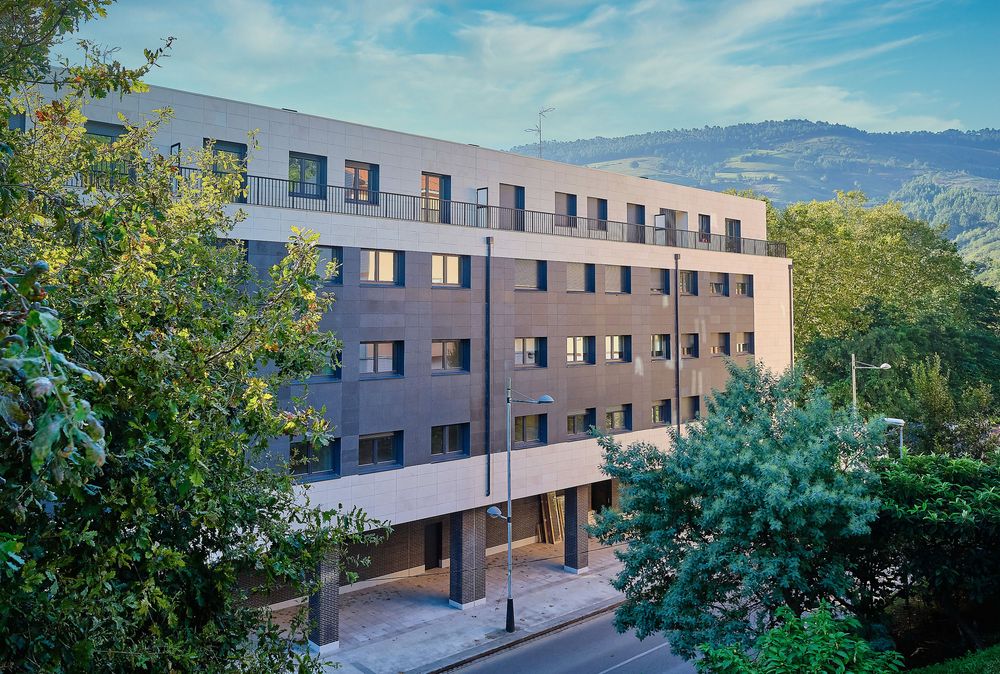 The Gorostiza Loft building seen from the road up to El Regato, surrounded by green hillsides