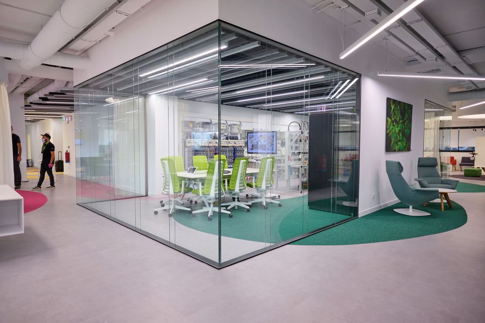 Glazed meeting room with green chairs next to the laboratories at the Smartgrid Innovation Hub